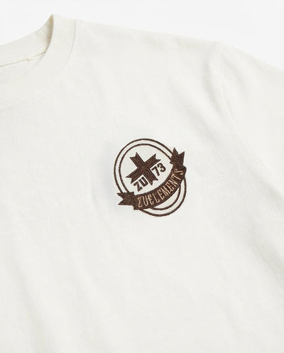 T-shirt girocollo maniche corte, ricamo lato cuore e taglio sul dietro